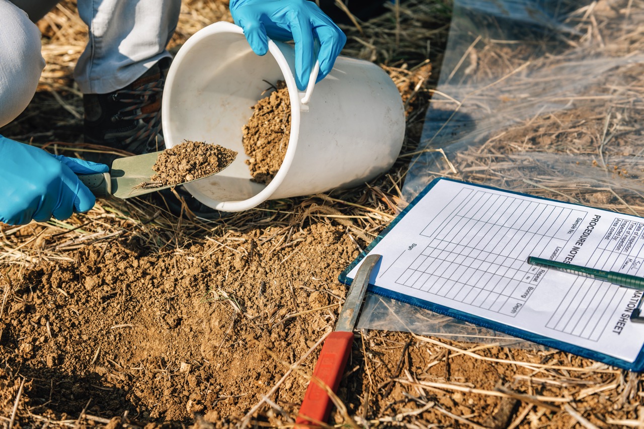Soil testing agronomy inspector taking soil sample